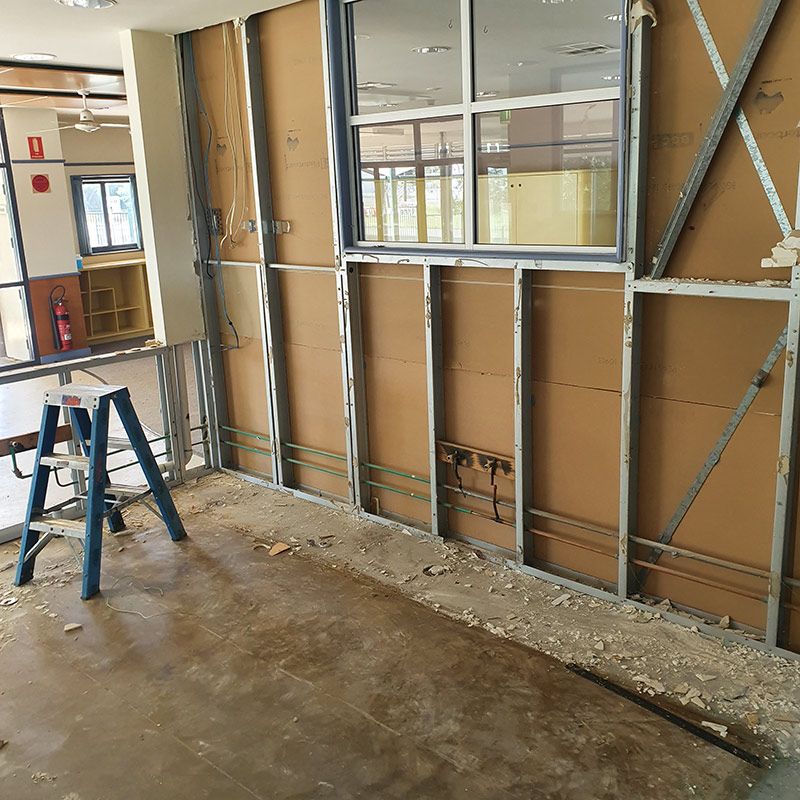 A Room Construction With A Steel Frame And Wooden Wall With Electrical Wiring — Entire Trades in Cessnock, NSW