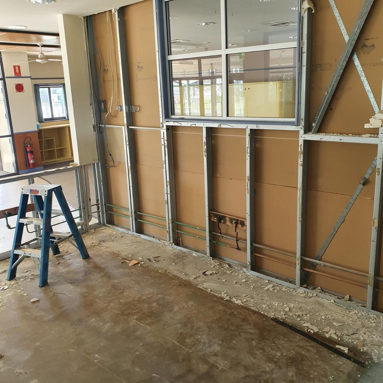 A Ladder Is Sitting in Front of A Wall that Is Being Remodeled — Entire Trades in Singleton, NSW