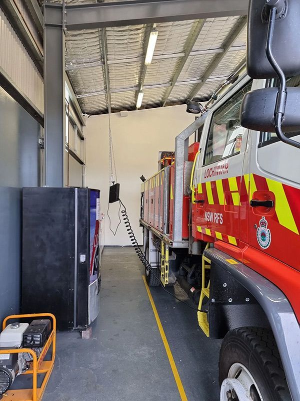 A Red And Yellow Fire Truck With Electrical Wiring — Entire Trades in Port Stephens, NSW