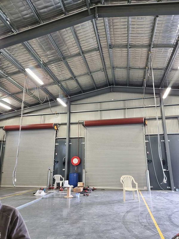 A Large Warehouse With New Lightings Installation — Entire Trades in Cessnock, NSW