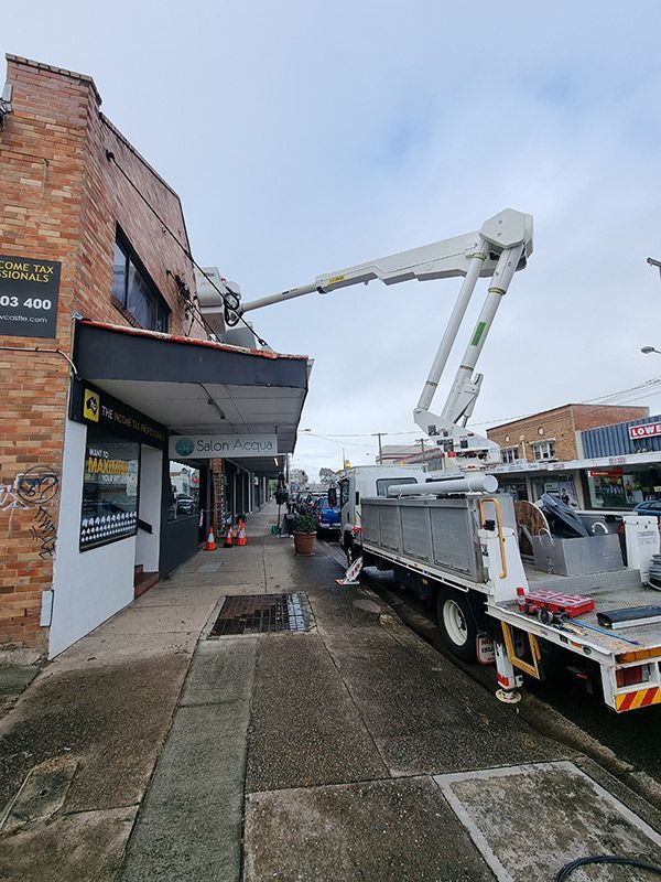 Fixing The Commercial Electrical With Truck — Entire Trades in Central Coast, NSW