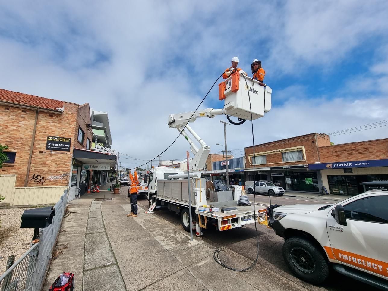 A Truck Is Parked on The Side of The Road Next to A Crane — Entire Trades in Maitland, NSW