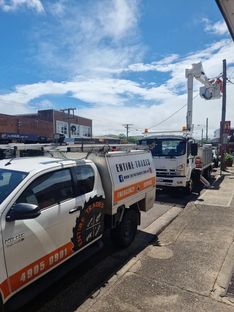 Two Trucks Are Parked Next to Each Other on The Side of The Road — Entire Trades in Maitland, NSW