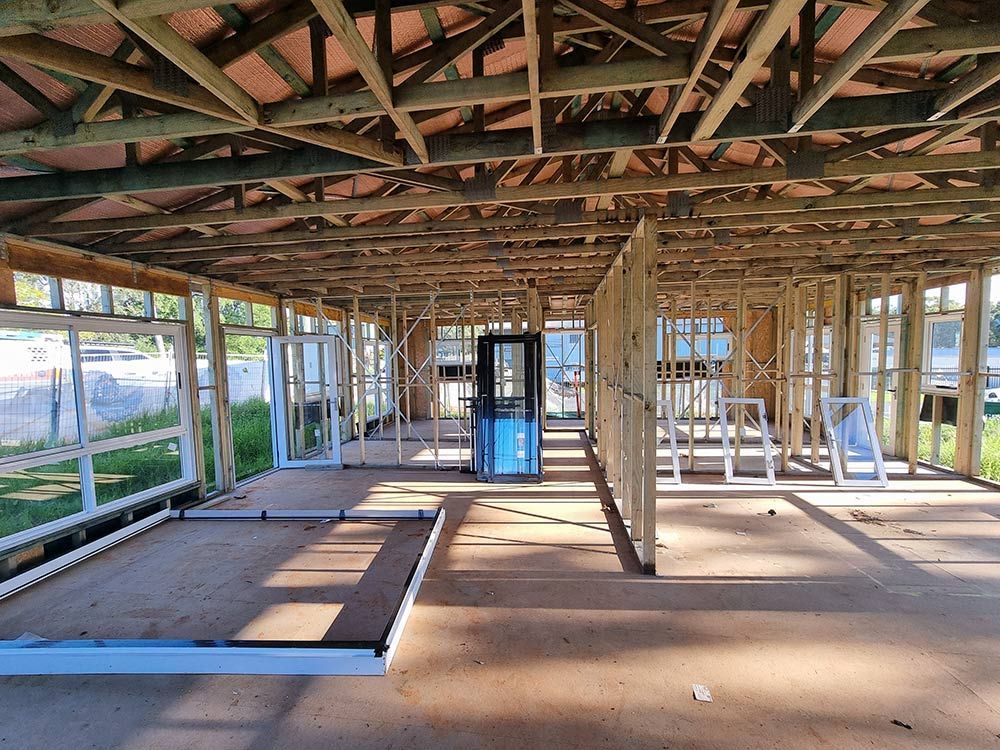 The Inside Of A Building Under Construction With A Lot Of Windows — Entire Trades in Central Coast, NSW