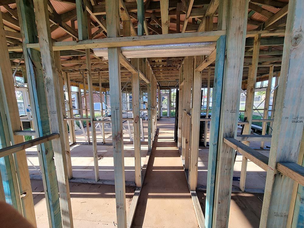 The Inside Of A Building Under Construction With Wooden Beams — Entire Trades in Central Coast, NSW