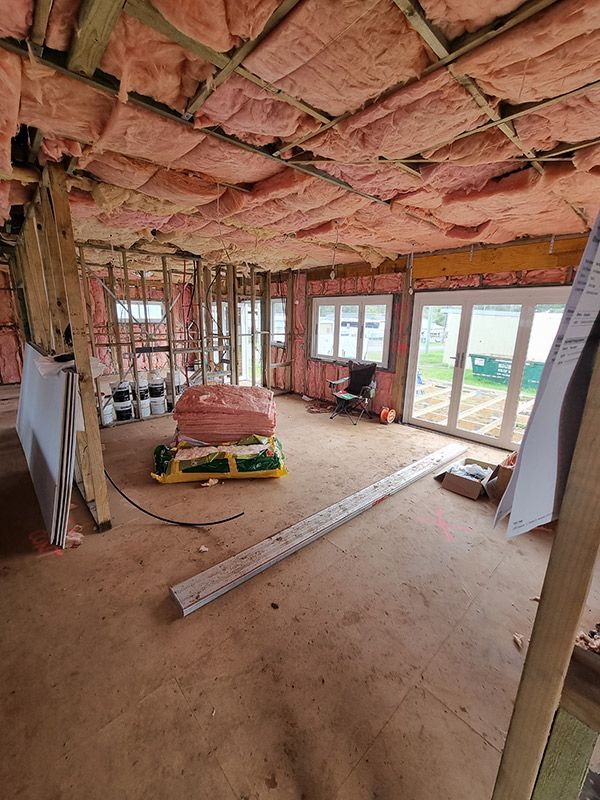 Interior Of A Room With Various Construction Tools And Insulation — Entire Trades in Port Stephens, NSW