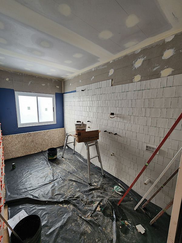 A Room With A Ladder And Buckets In It Is Being Remodeled — Entire Trades in Central Coast, NSW