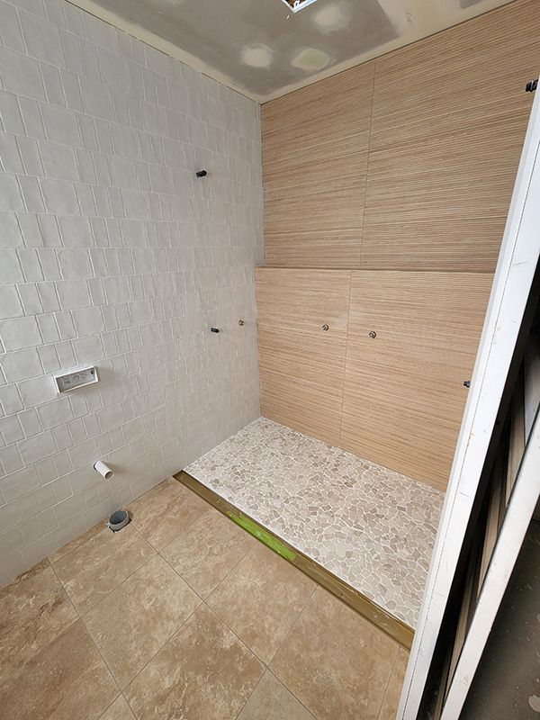 A Bathroom With A Walk-in Shower Under Construction — Entire Trades in Singleton, NSW