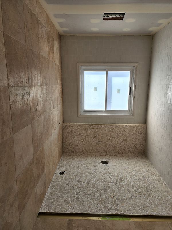 A Bathroom With A Sliding Glass Door And A Window — Entire Trades in Central Coast, NSW