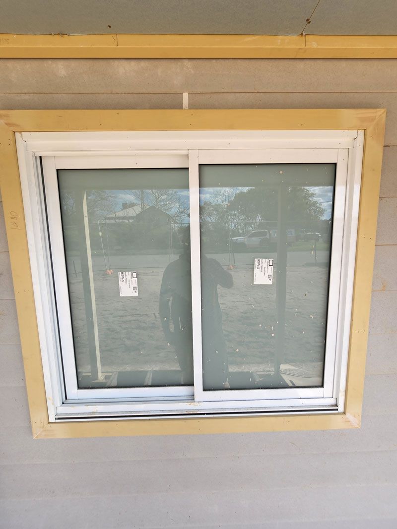 A Window With A Sliding Glass Door On A House — Entire Trades in Central Coast, NSW
