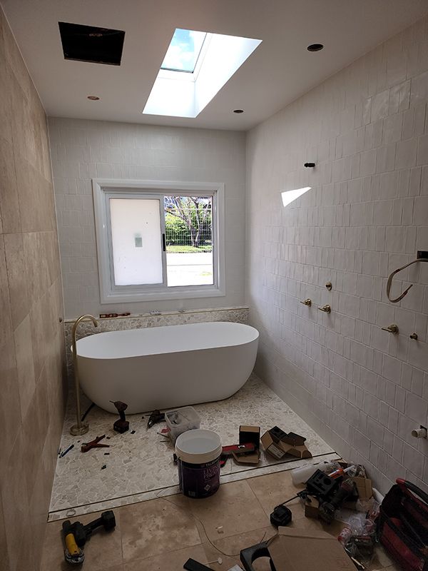 A Bathroom Under Construction With A Bathtub And A Skylight — Entire Trades in Singleton, NSW