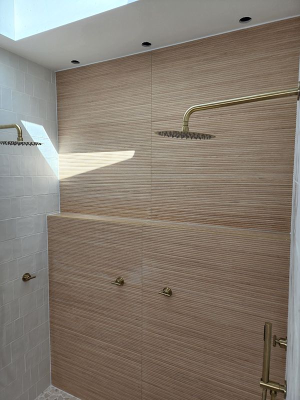 A Bathroom With Two Shower Heads And A Skylight With Beautiful Wall — Entire Trades in Singleton, NSW