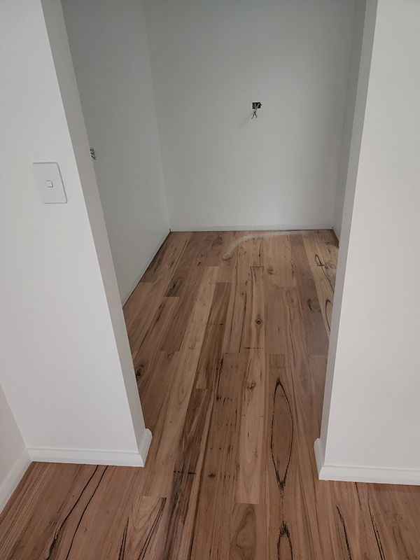 A Room With Hardwood Floors And A Closed Door — Entire Trades in Cessnock, NSW