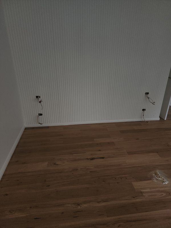A Room With A Wooden Floor And A White Wall With Wiring For The Outlet — Entire Trades in Cessnock, NSW