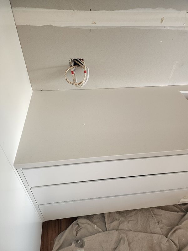 A White Cabinet With A Light Switch On Top — Entire Trades in Cessnock, NSW