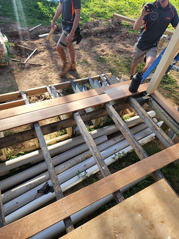 Two Men Diligently Working Together On A Wooden Structure — Entire Trades in Singleton, NSW