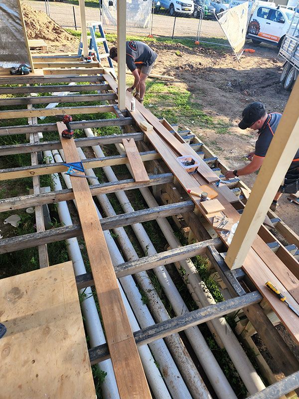Men Working Together On A Wooden Deck — Entire Trades in Cessnock, NSW