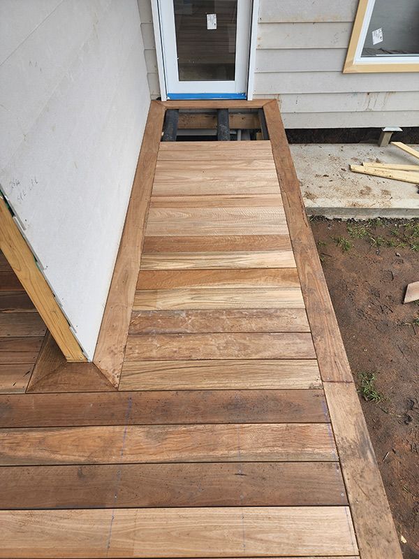 A Wooden Deck Is Under Construction Beside The House — Entire Trades in Singleton, NSW