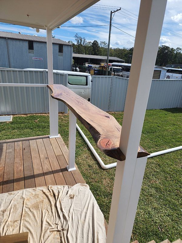 A Piece Of Wood Is Sitting On Top Of A Wooden Deck — Entire Trades in Singleton, NSW