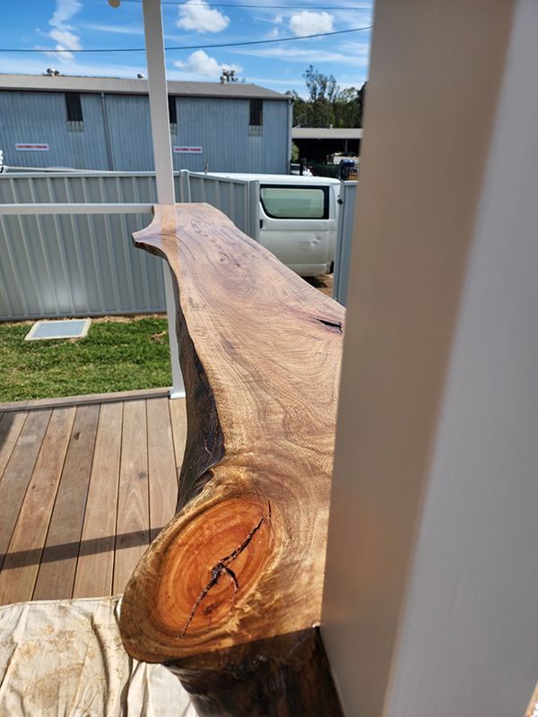 Tree Trunk On Wooden Deck — Entire Trades in Singleton, NSW