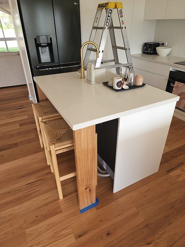 A Kitchen Island With A Ladder On Top Of It — Entire Trades in Central Coast, NSW