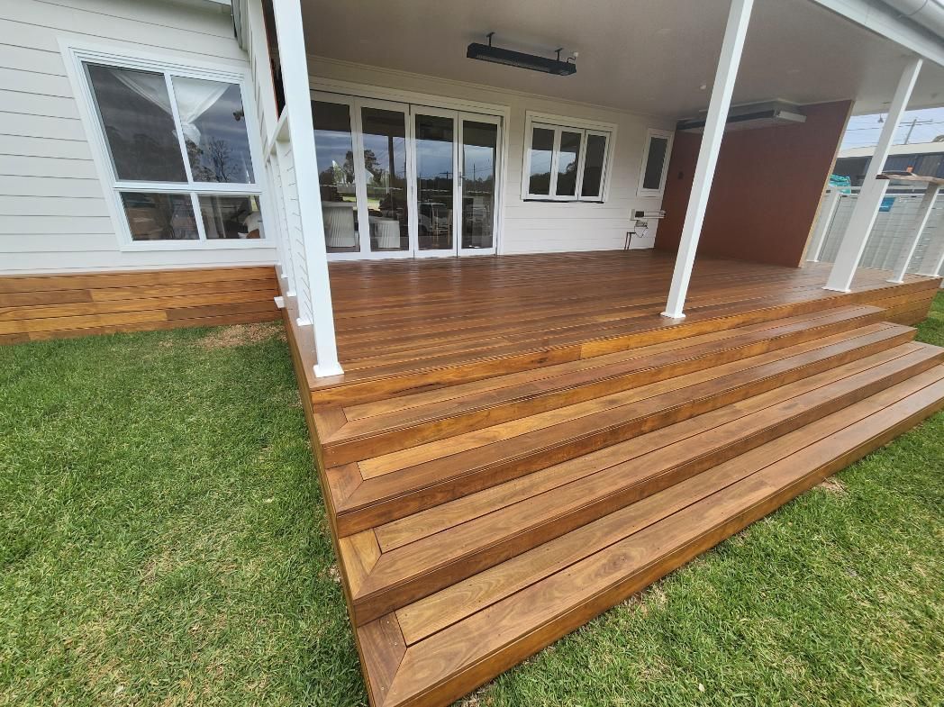 A House with A Wooden Deck and Stairs in Front of It — Entire Trades in Maitland, NSW