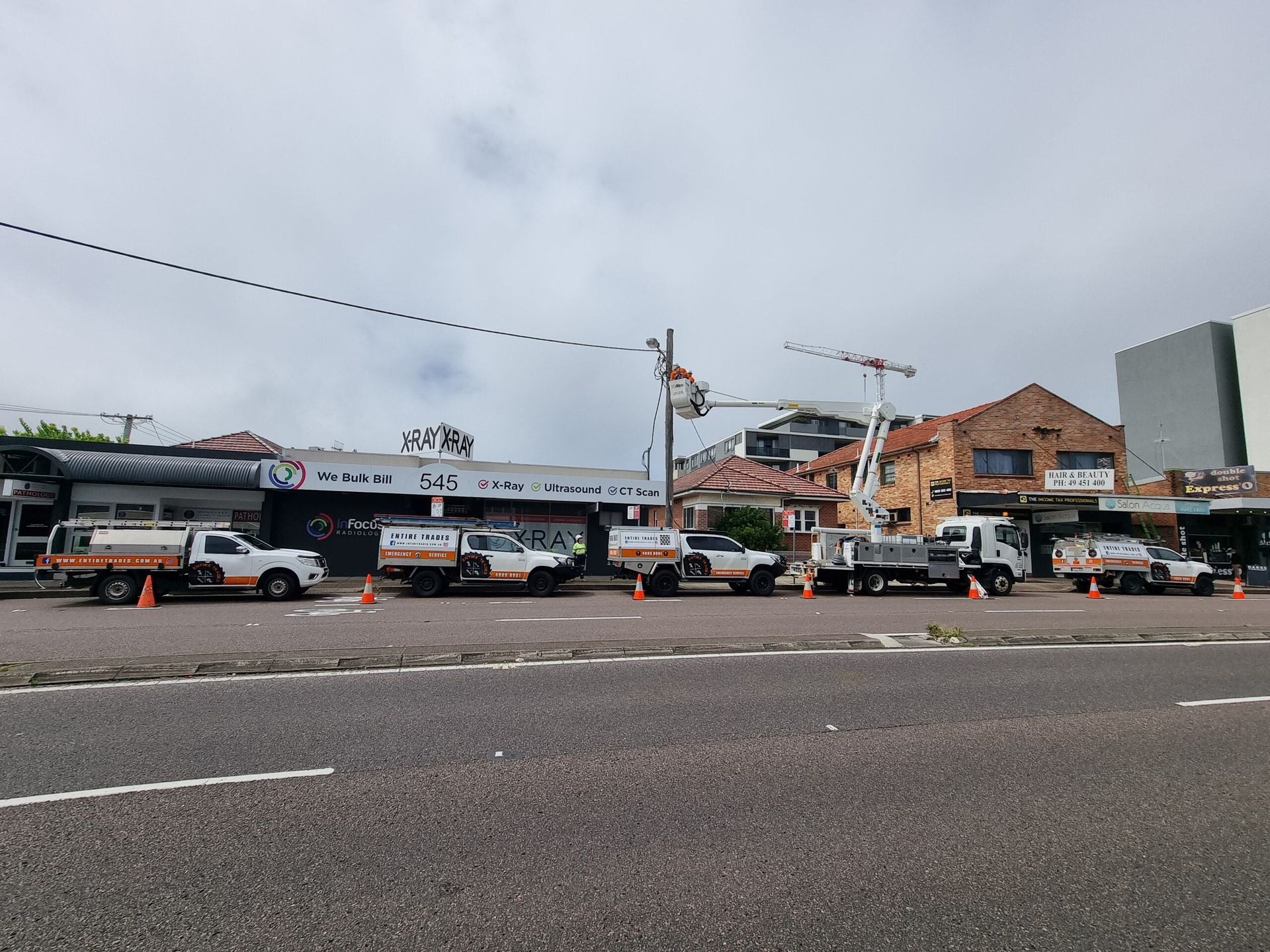 Business Vehicles Parked Outside Shops Whilst Power Line Gets Fixed — Entire Trades in Maitland, NSW