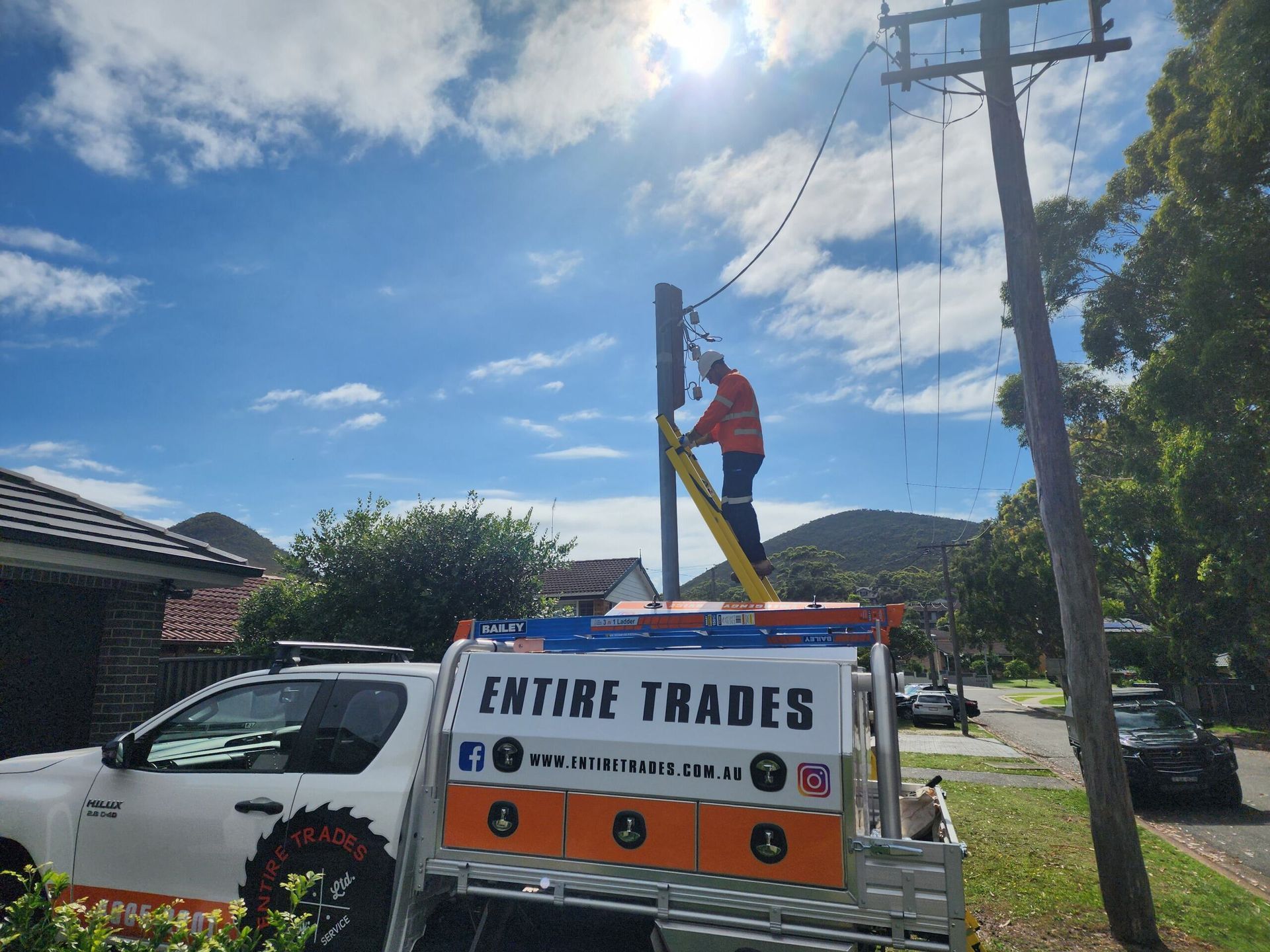 Man on Ladder Fixing Power Line — Entire Trades in Maitland, NSW