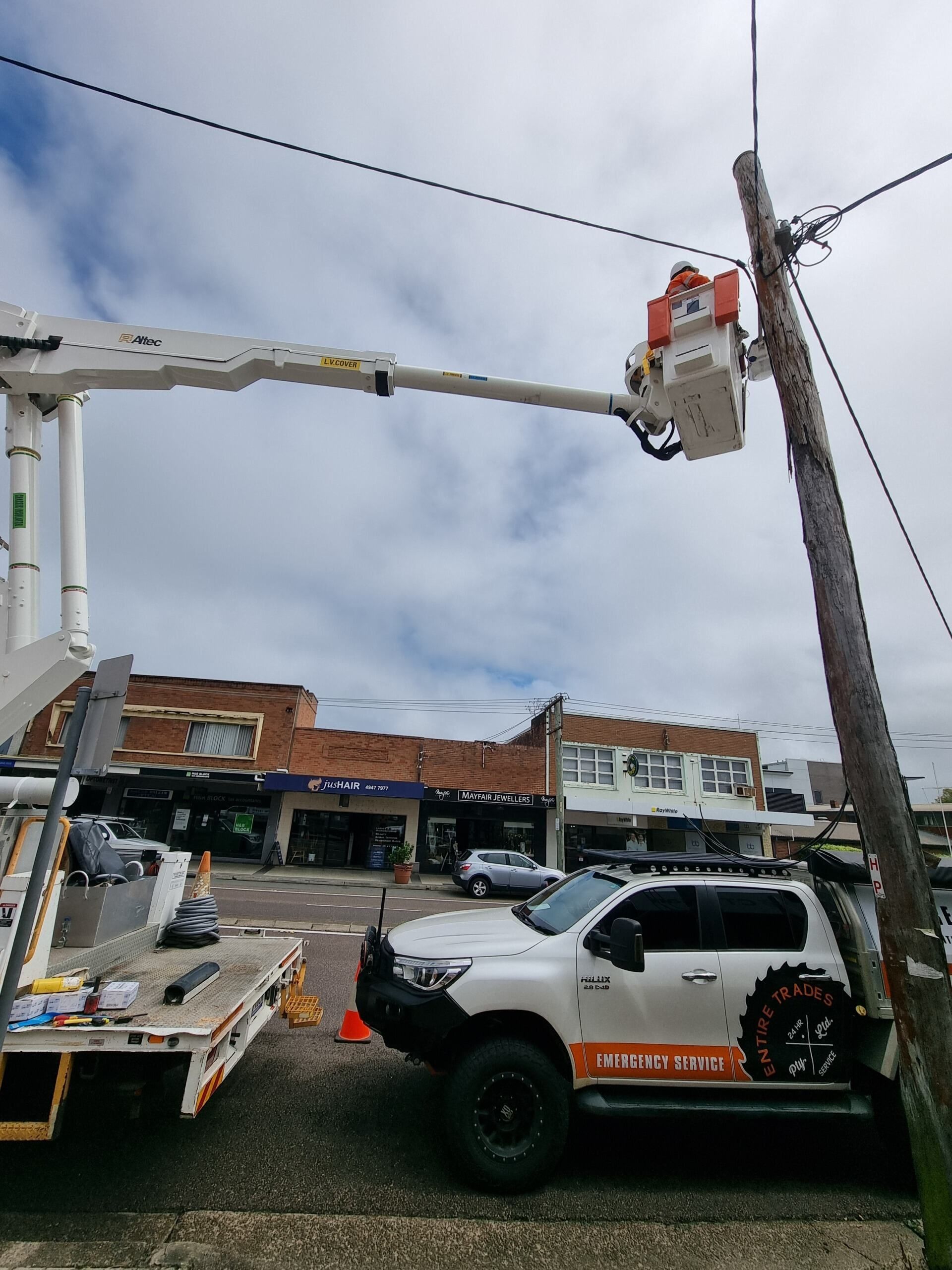 Man Fixing Power Line In Street — Entire Trades in Maitland, NSW
