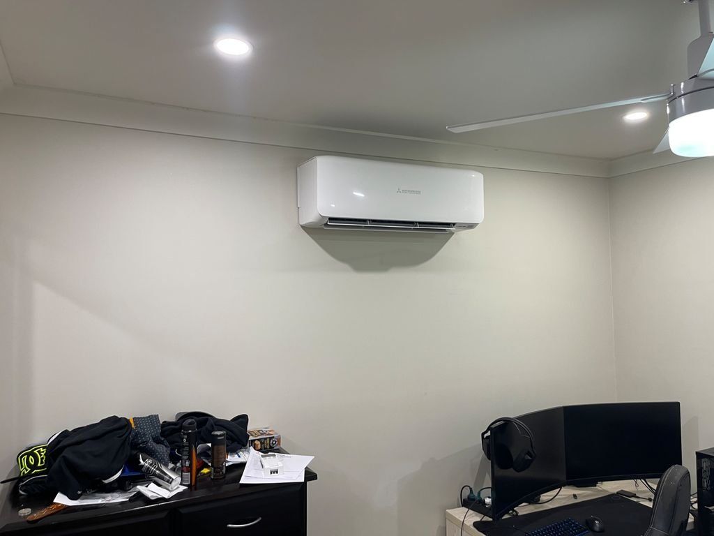 A Living Room with A Couch and A Ceiling Fan — Entire Trades in Maitland, NSW