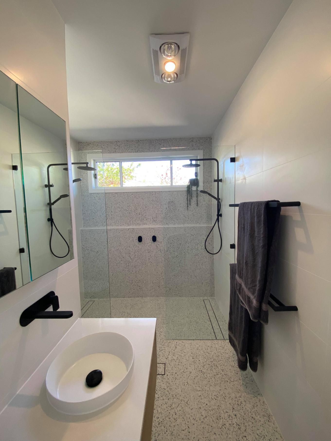 A Bathroom with A Sink, Mirror and Shower — Entire Trades in Maitland, NSW