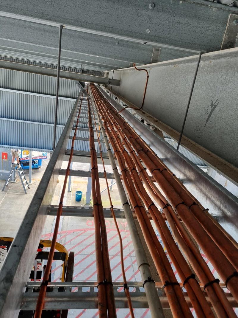 A Ladder With A Bunch Of Wires Hanging From It — Entire Trades in Maitland, NSW