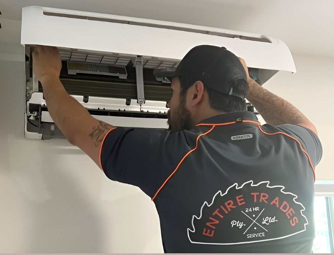 Technician installing a wall-mounted air conditioner, showcasing air conditioning Maitland services.