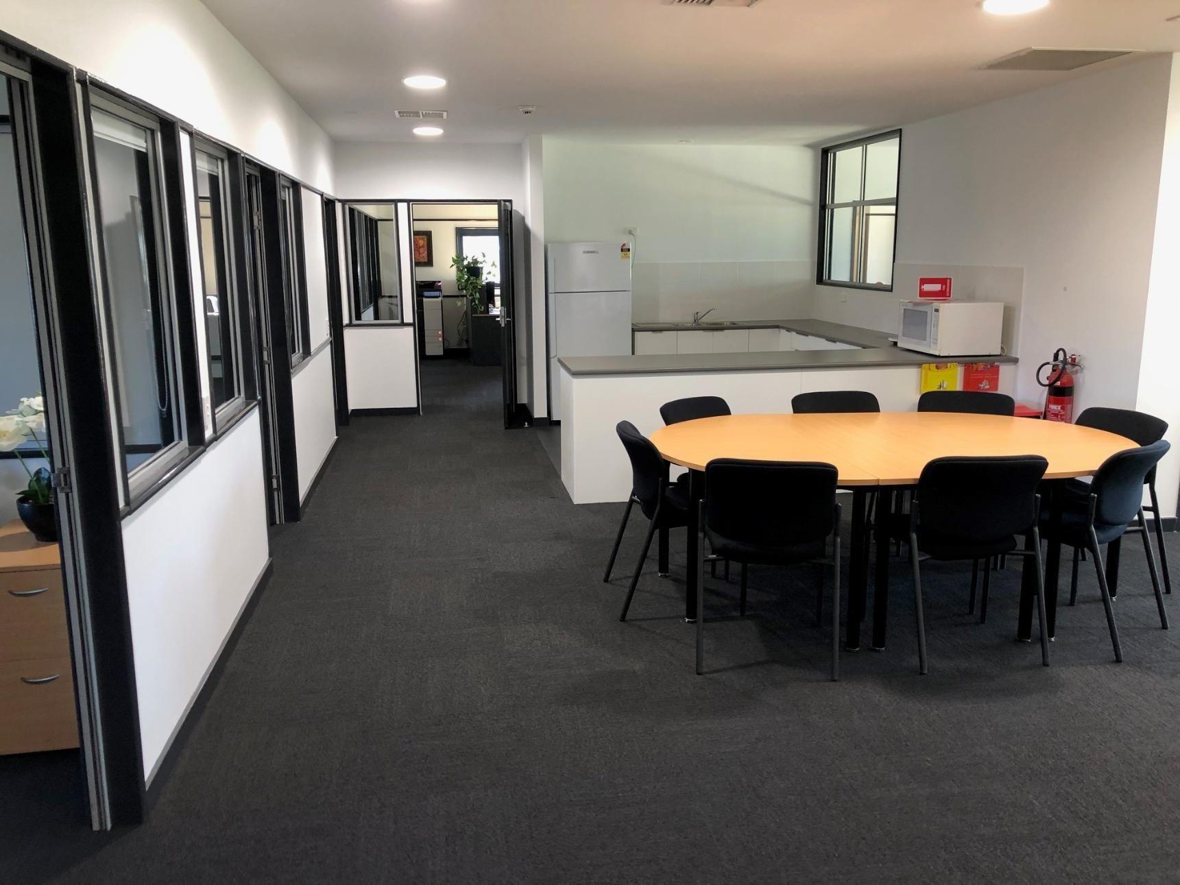 A Long Hallway with A Table and Chairs in The Middle — Entire Trades in Maitland, NSW