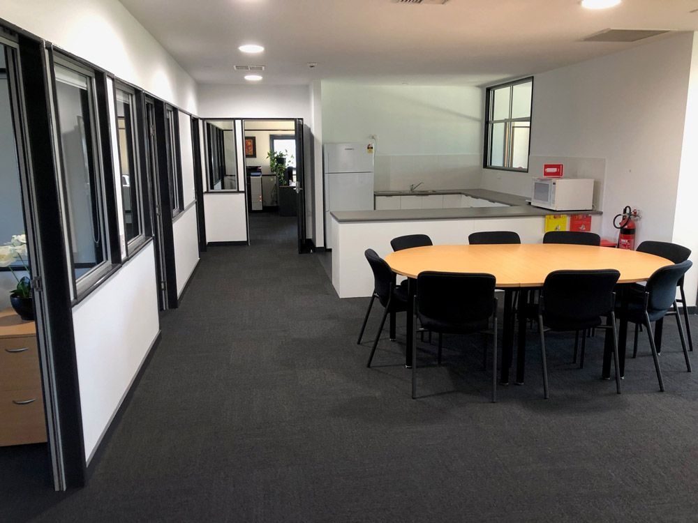 A Long Hallway With A Table And Chairs In The Middle And Open Lights — Entire Trades in Central Coast, NSW