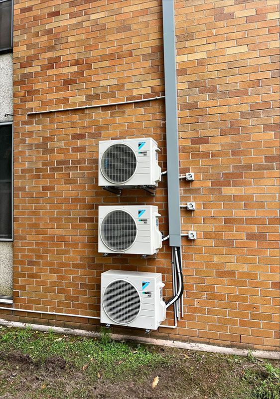 Three Air Conditioner Outer Units Installed On The Wall — Entire Trades in Maitland, NSW