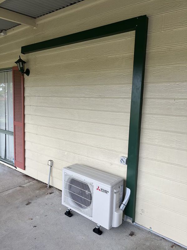 Mitsubishi Air Conditioner Outer Unit Installed On Wall — Entire Trades in Maitland, NSW