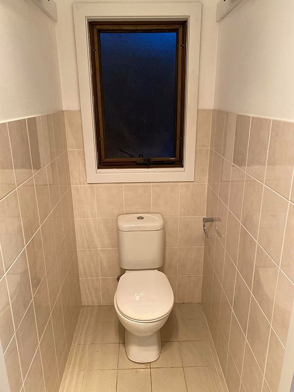 Interior Of Bathroom Featuring Toilet And Window For Fresh Air And Sunlight — Entire Trades in Cessnock, NSW