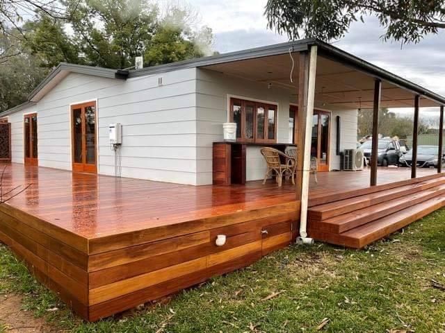 A House with A Large Wooden Deck in Front of It — Entire Trades in Maitland, NSW