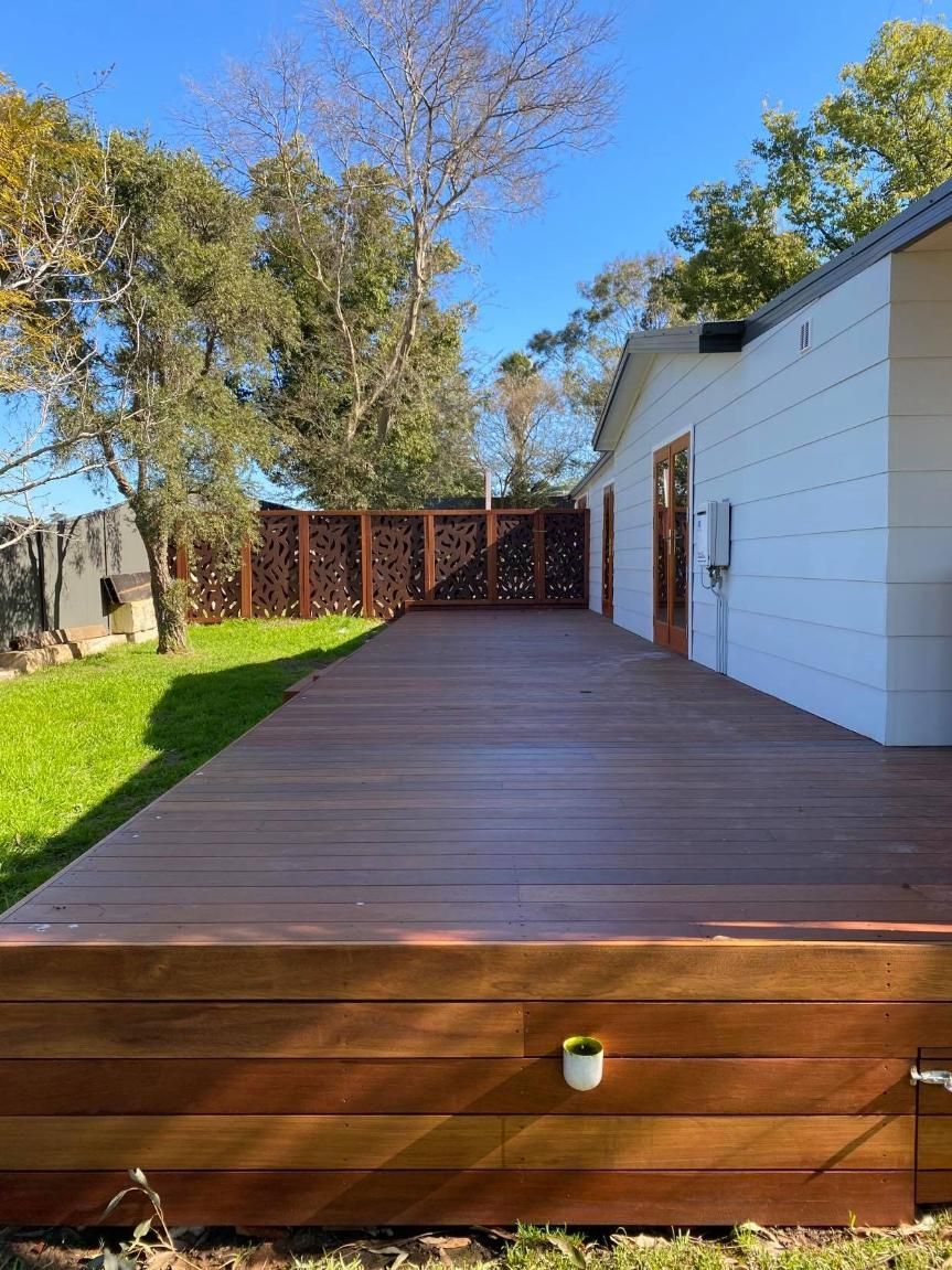 A Large Wooden Deck Is in The Backyard of A House — Entire Trades in Maitland, NSW