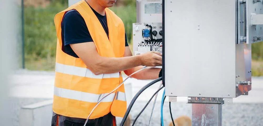 Electrician Inspecting Electrical Switch Box — Entire Trades in Port Stephens, NSW
