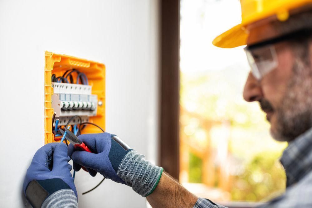 Electrician Installing Electrical Wiring — Entire Trades in Maitland, NSW