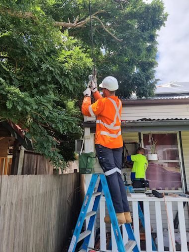 Electrician on A Ladder Fixing Electrical Wires