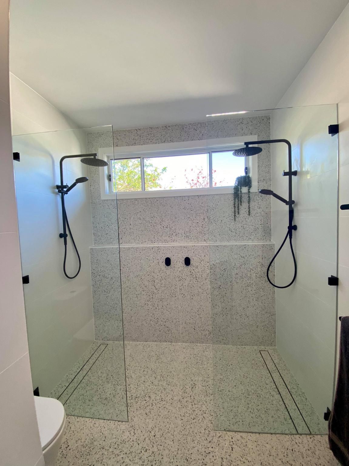 A Bathroom with Two Showers and A Toilet — Entire Trades in Maitland, NSW