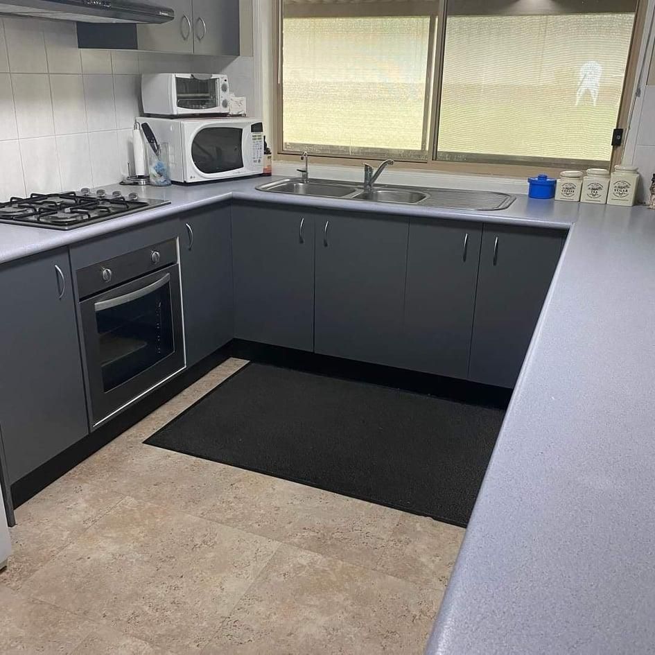 A Kitchen with Gray Cabinets, a Stove, a Microwave, a Sink, and A Window — Entire Trades in Maitland, NSW