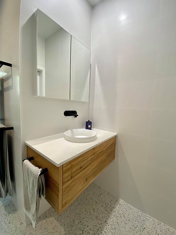 Bathroom Featuring Wooden Vanity And Mirror — Entire Trades in Port Stephens, NSW