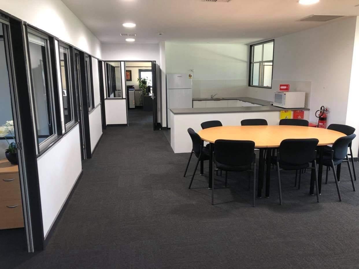 A Long Hallway with A Table and Chairs in It — Entire Trades in Maitland, NSW