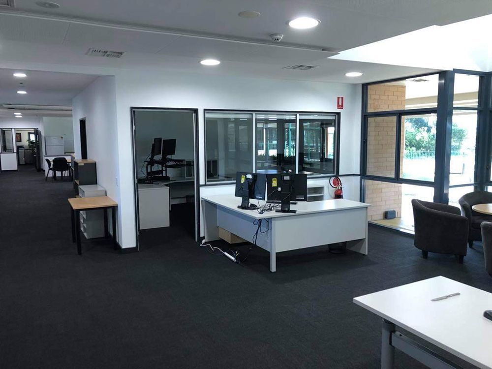 A Large Office With A Lot Of Desks And Chairs With Open Three Lights — Entire Trades in Singleton, NSW