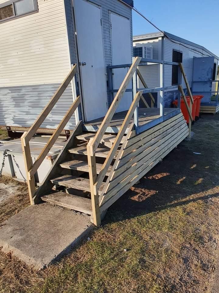 A Set of Wooden Stairs Leading up To a Building — Entire Trades in Maitland, NSW