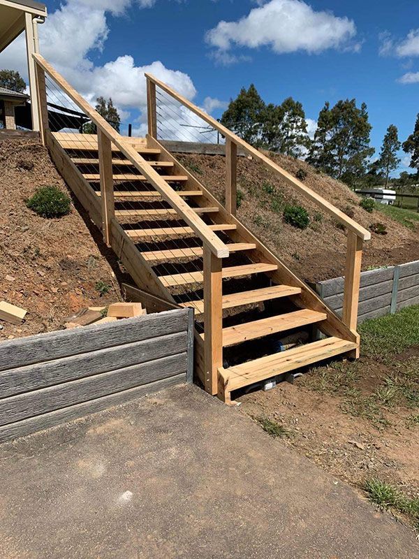 A Set Of Wooden Stairs Ascends To A House On A Hill — Entire Trades in Singleton, NSW